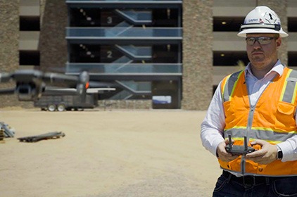 Construction worker flying drone