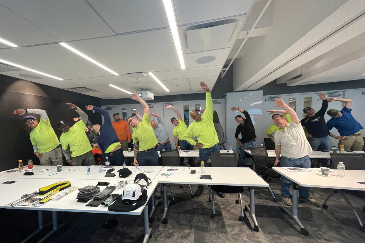 Employees at Structure Tone stretching in a meeting room