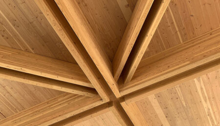 Wooden beams in a cross pattern on a ceiling.