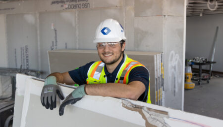 Structure Tone employee on site of a project wearing full personal protective equipment