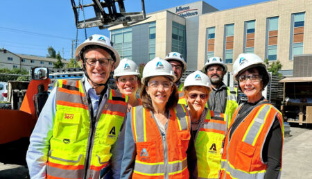 A group standing outside Jefferson Healthcare in full PPE