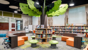 A unique library featuring a bookshelf designed in the shape of a tree.