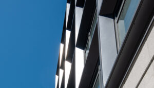 A building stands against a clear blue sky, showcasing its architecture and the vibrant atmosphere.
