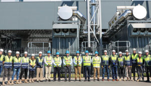 row of construction workers in safty gear in from of a building at Structure Tone mission Critical Amsterdam