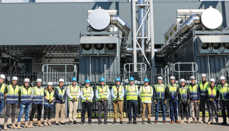 row of construction workers in safty gear in from of a building at Structure Tone mission Critical Amsterdam
