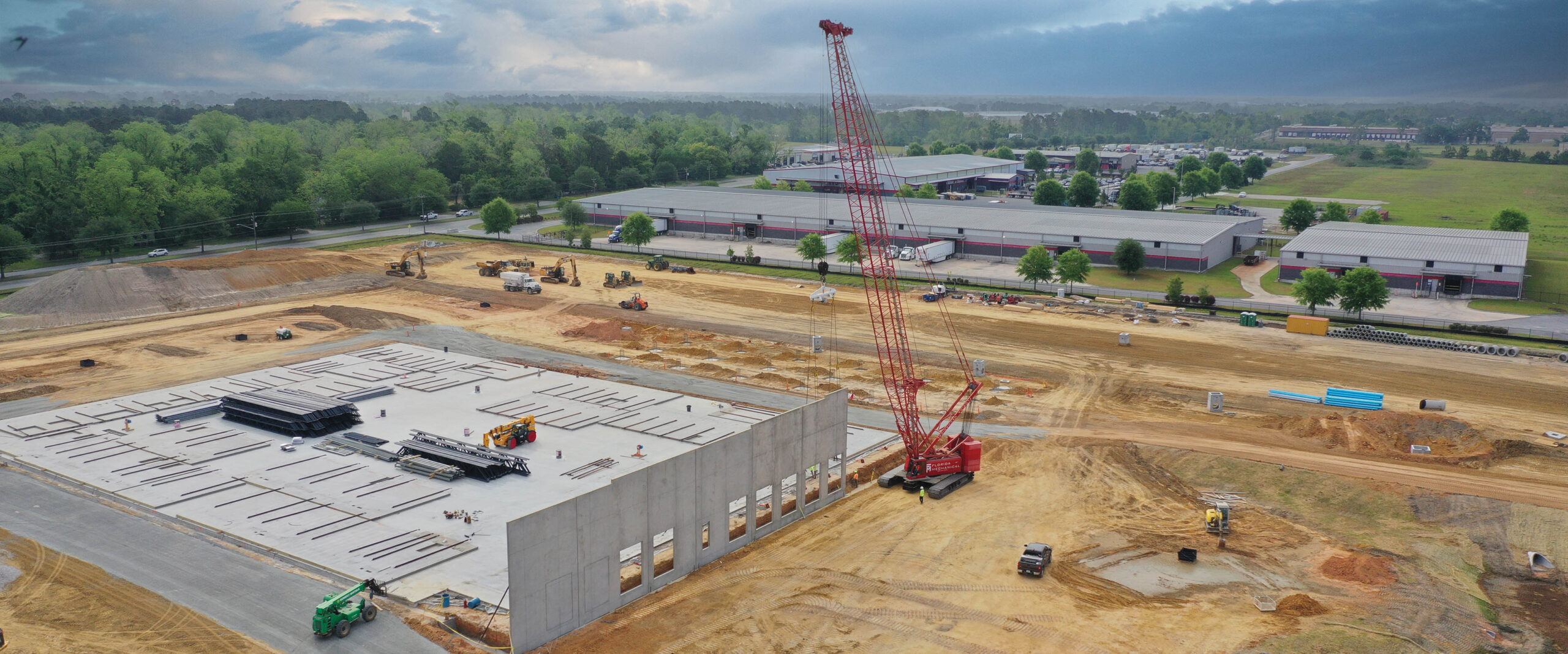 Construction site with dirt and concrete structure and a Crain