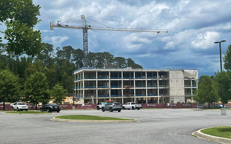 Construction of the FSU building with Crain on top built by Ajax Building Company.