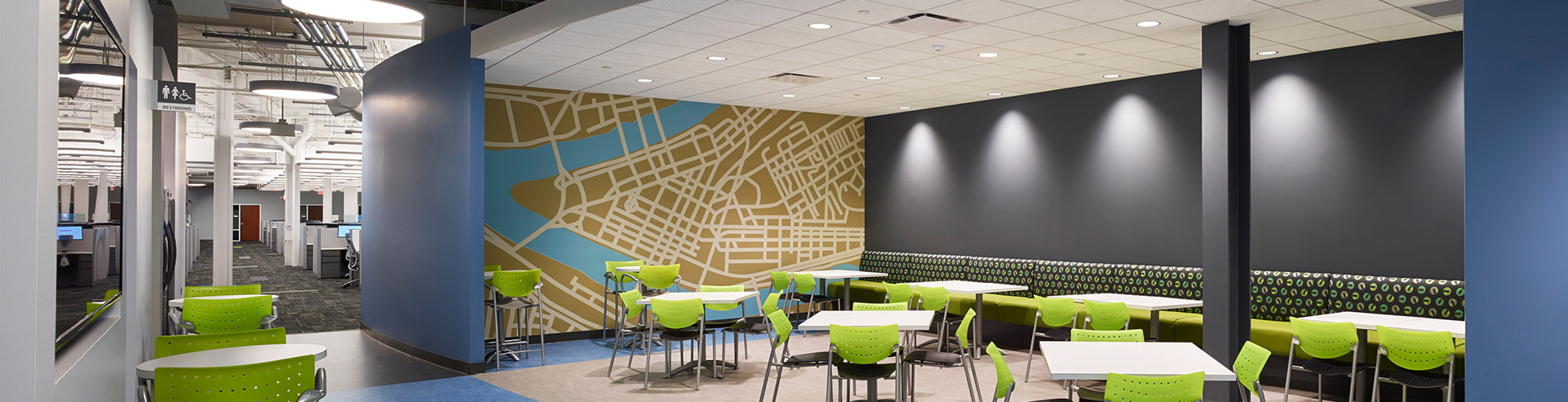 Picture of a lounge or eating area with lime green chairs and a map of downtown Manhattan