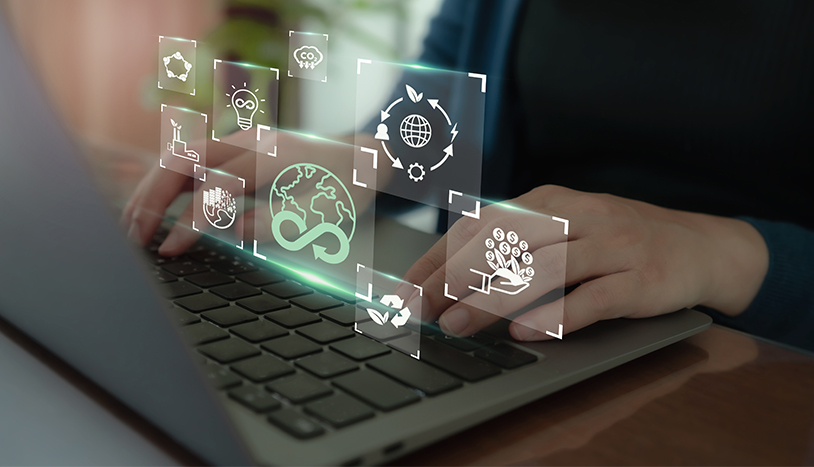 computer with hands typing and imagery of sustainability logos
