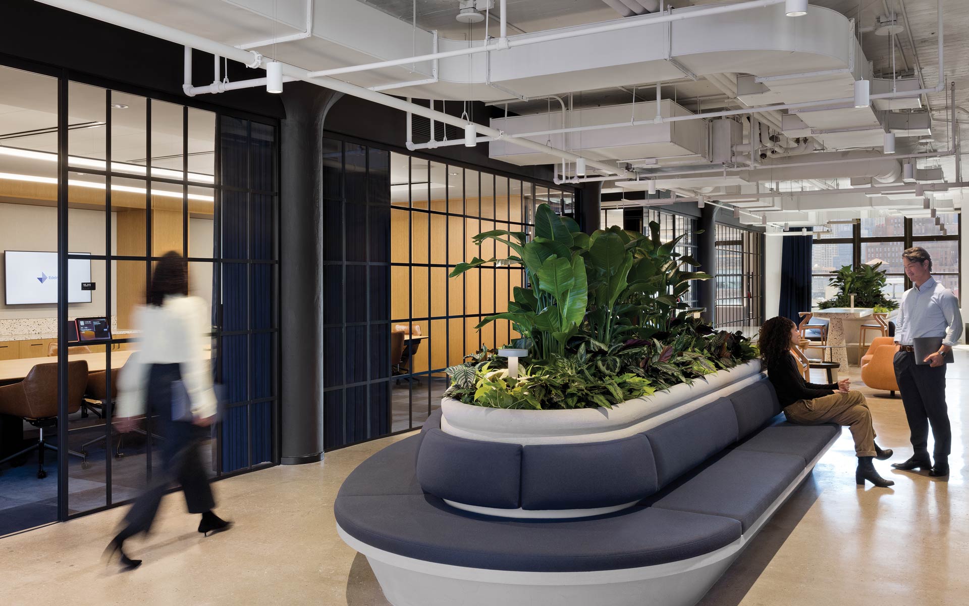 An open office hallway with couch seating