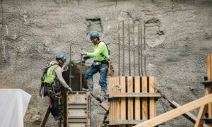 Two construction workers on a project site
