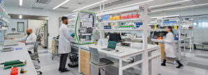 What the Rise of Life Sciences Megaprojects Means for Owners An image of a lab with three lab scientists working