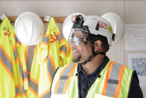How A Helmet Made A Difference Construction man with a chin-strap helmet.