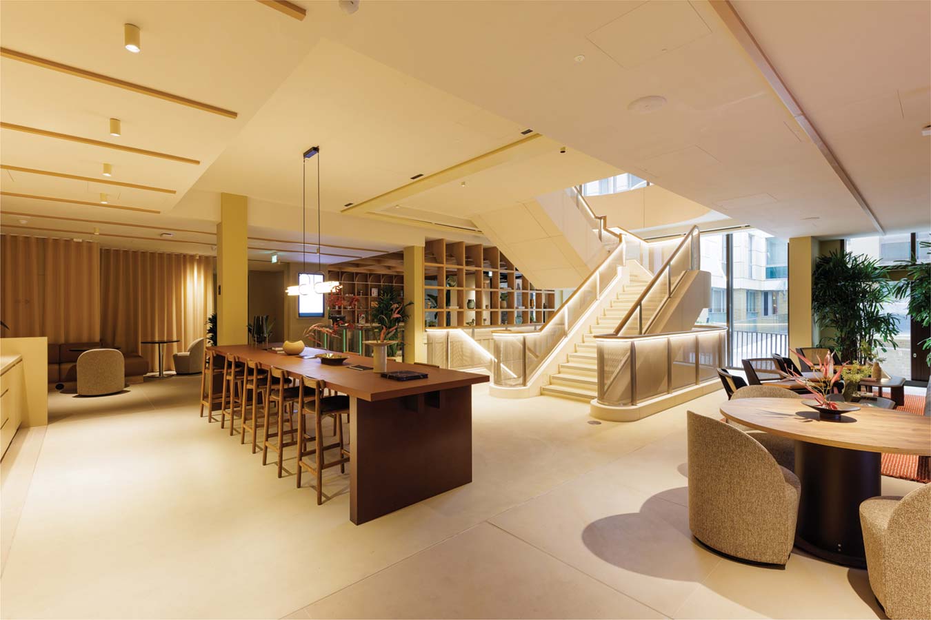 Lounge area with staircase and wooden seating.
