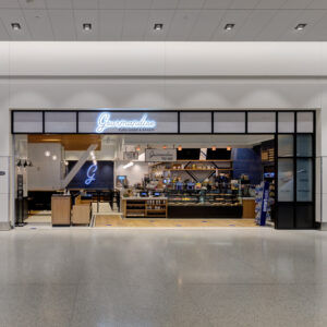 Ghost in the Night: The Expertise Behind Building in an Active Airport Gourmandise Euro-Diner & Bakery storefront inside Salt Lake City International Airport, featuring an open counter, display cases, and seating.