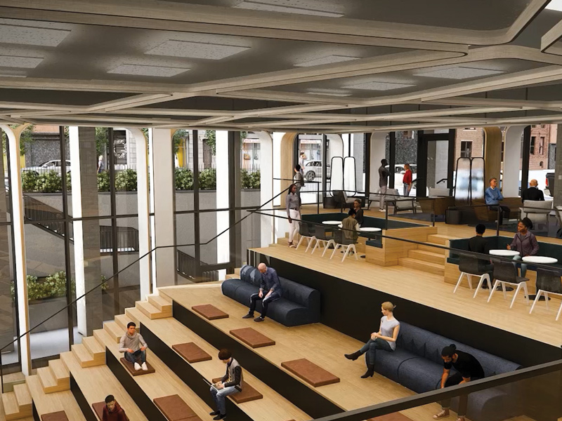 Multi-level office atrium with tiered wood seating, dark sofas, tables, and people seated throughout the space.